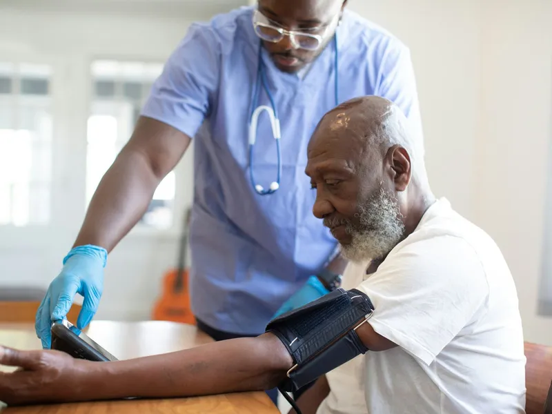 A physician checking a patient’s blood pressure.