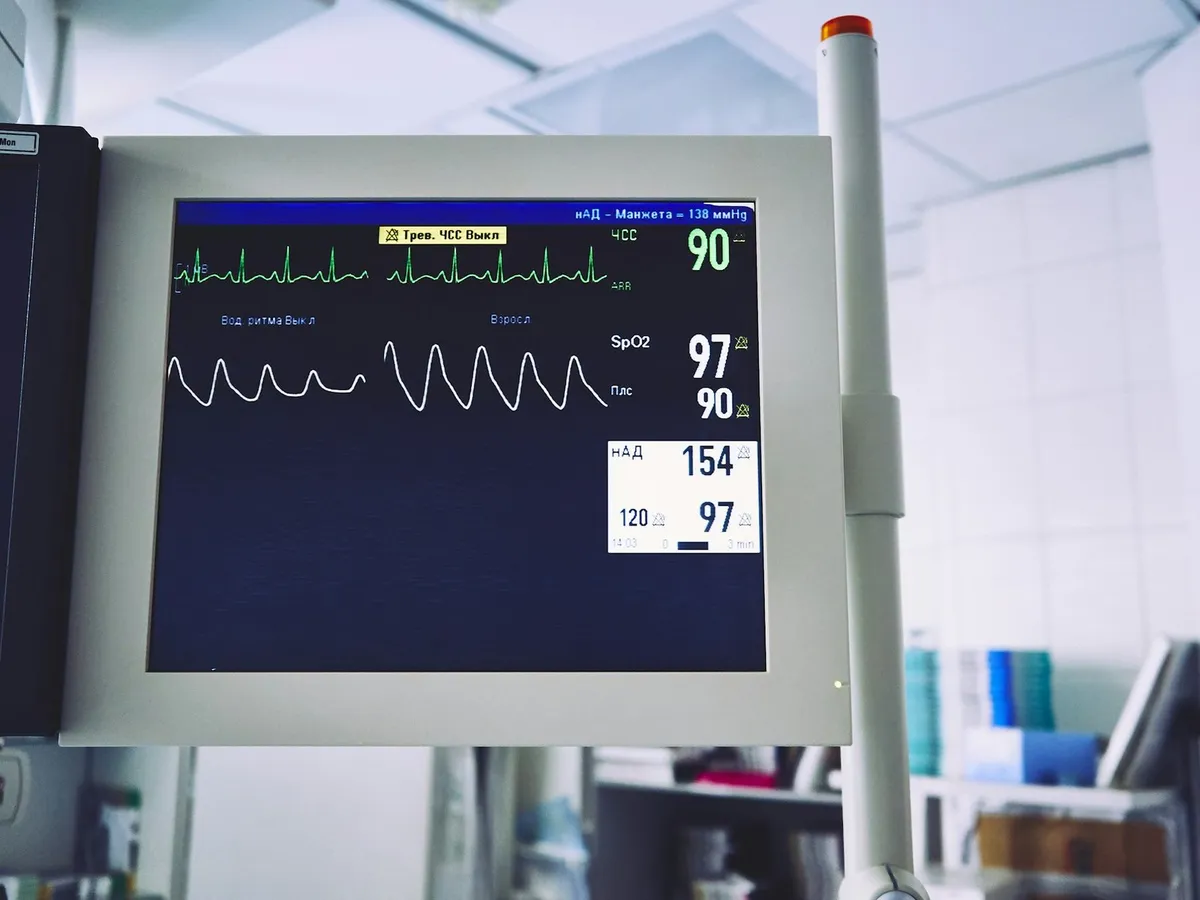 Patient monitor displaying physiological waveforms in an operating room.