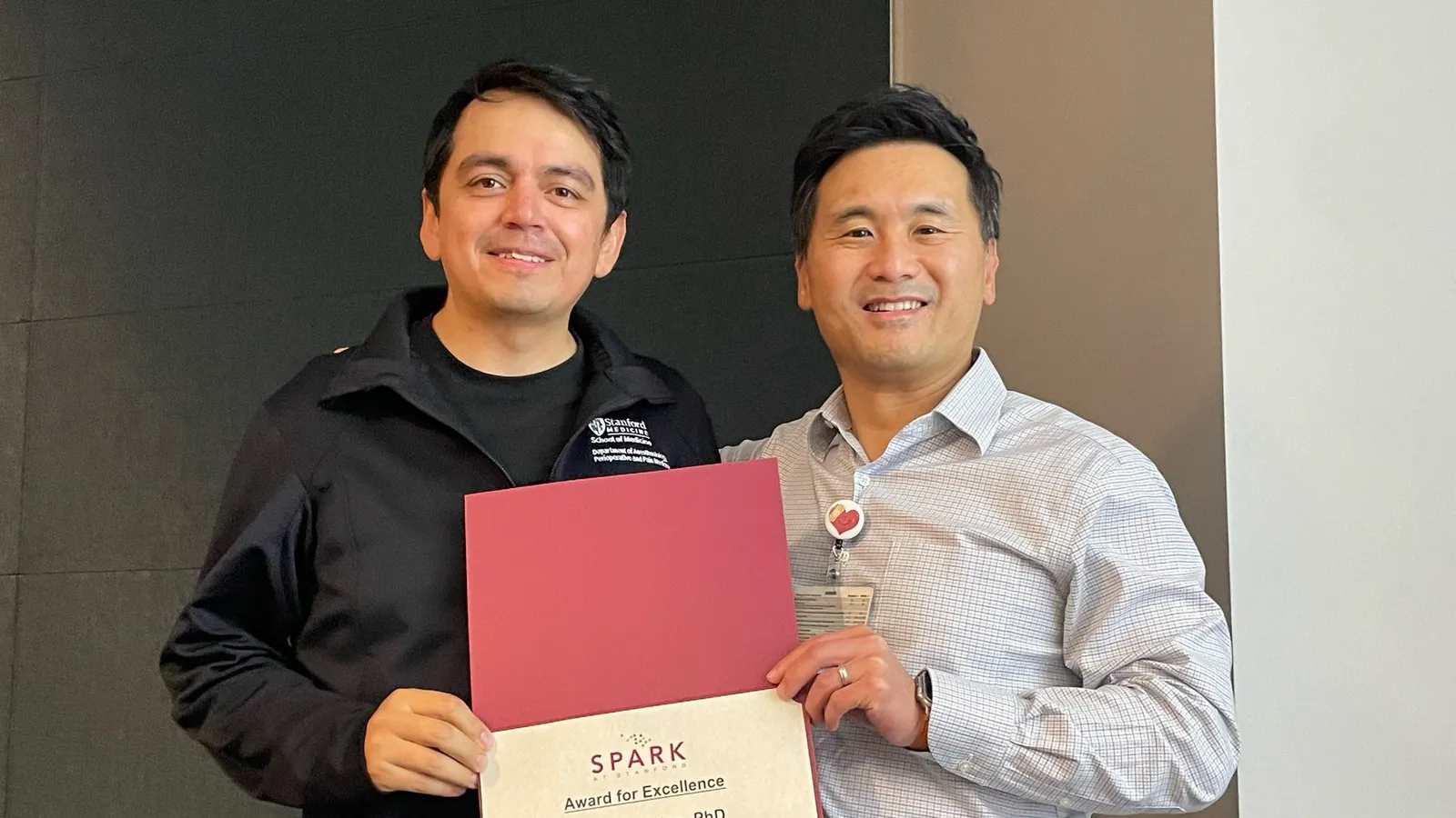 Gustavo Balanza and Patrick Purdon holding the SPARK Award for Excellence certificate at Stanford University School of Medicine, October 29, 2025.